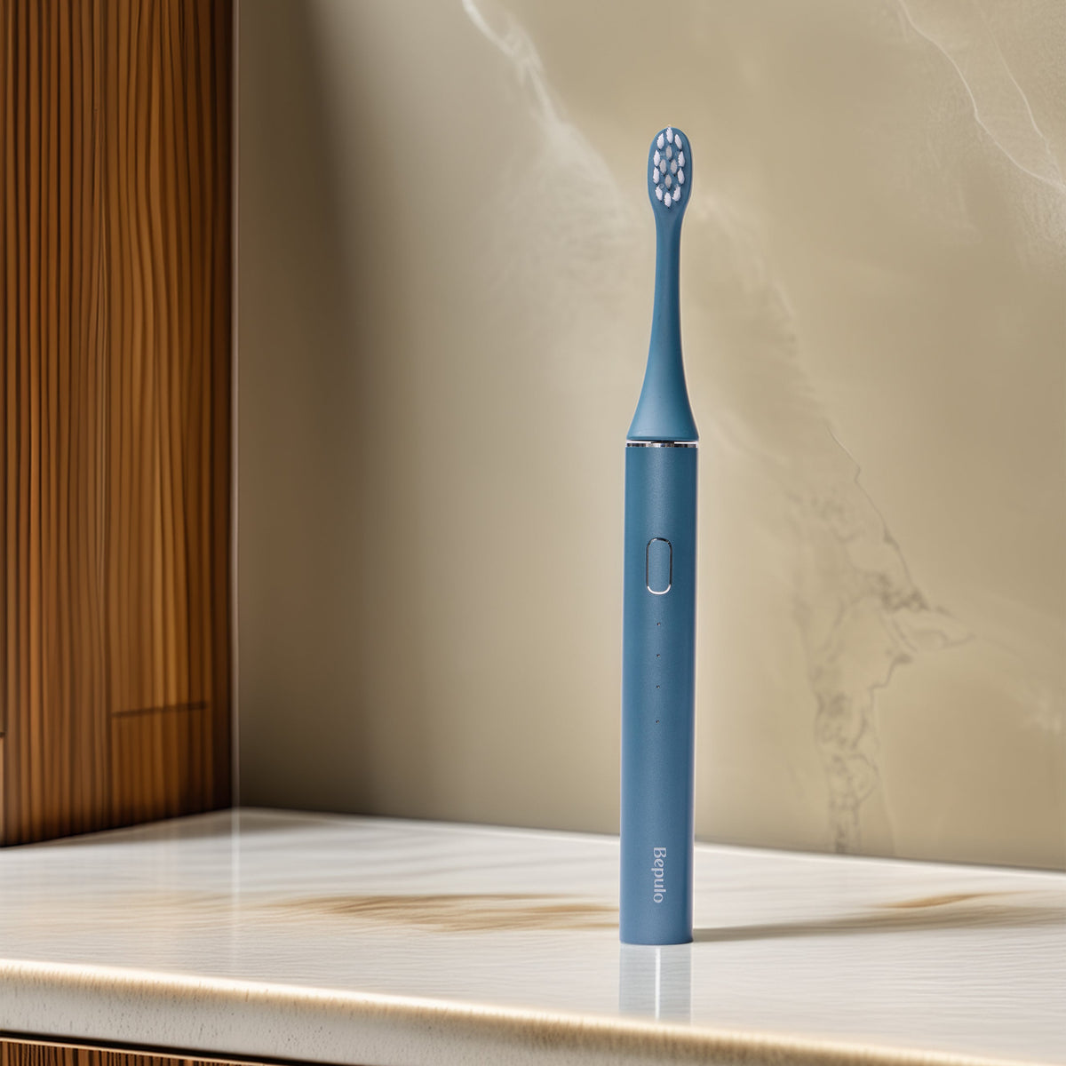 A Sapphire Blue Bepulo Next sonic electric toothbrush standing upright on a marble bathroom counter. #colour_sapphire blue