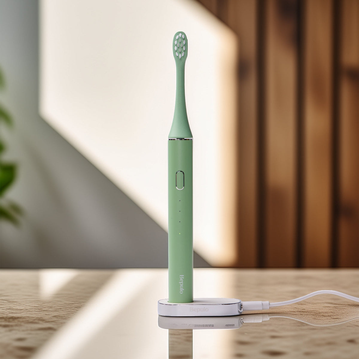 Bepulo Next pistachio green sonic electric toothbrush charging upright on its magnetic base. #colour_pistachio green