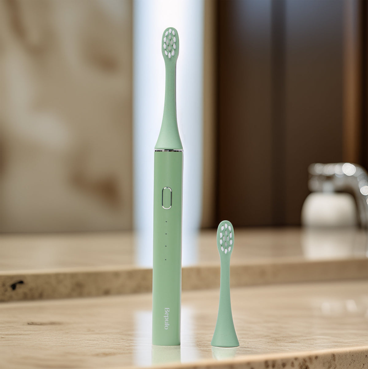 Bepulo Next sonic electric toothbrush in pistachio green standing on a stone bathroom vanity. #colour_pistachio green
