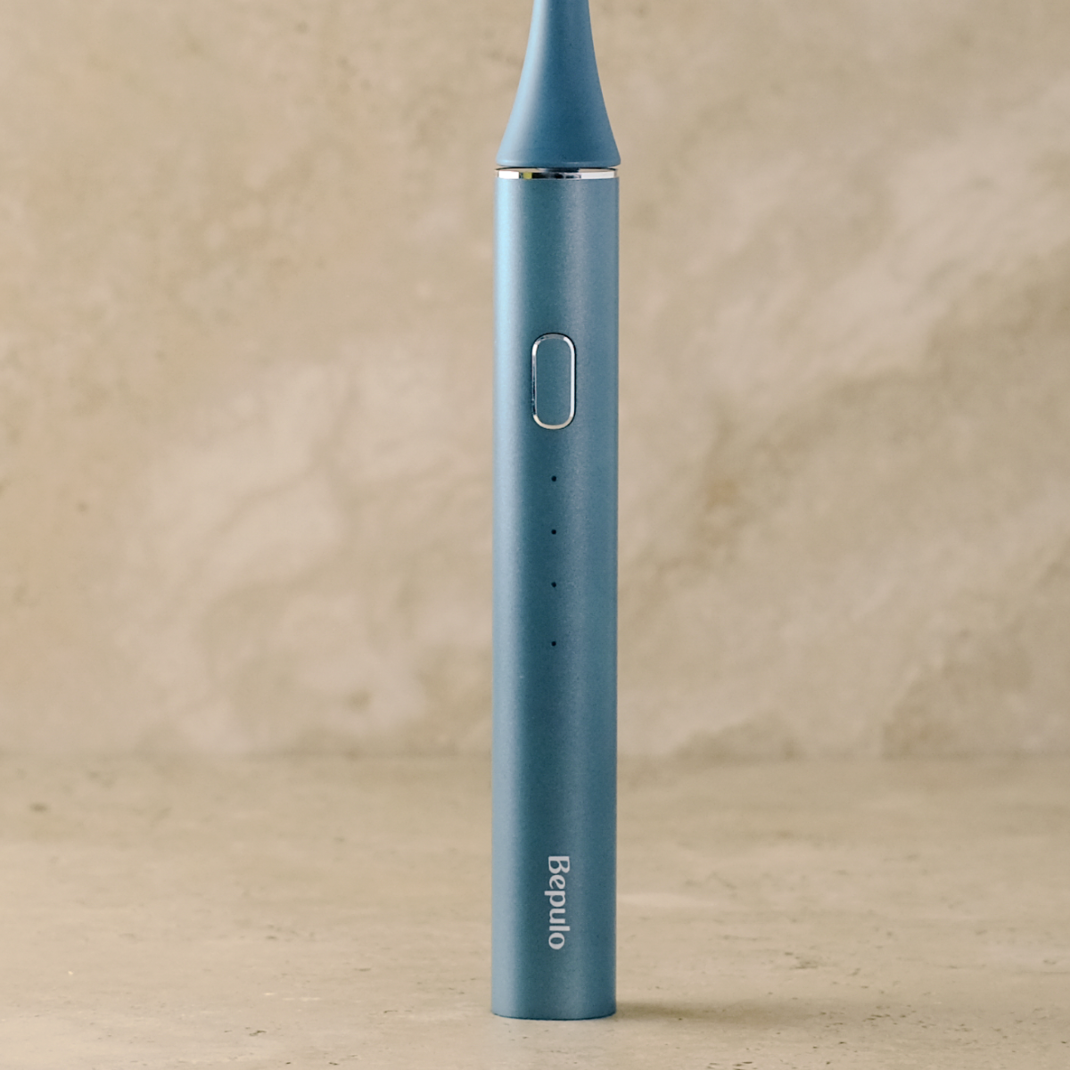 Close-up of Sapphire Blue Bepulo Next sonic electric toothbrush standing upright. #colour_sapphire blue