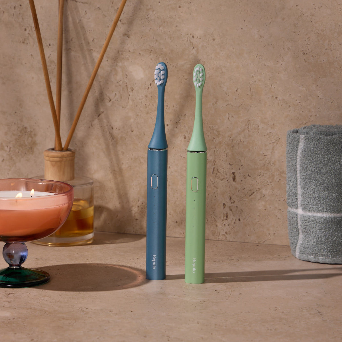 Two Bepulo Next sonic electric toothbrushes in sapphire blue and pistachio green. #colour_sapphire blue and pistachio green