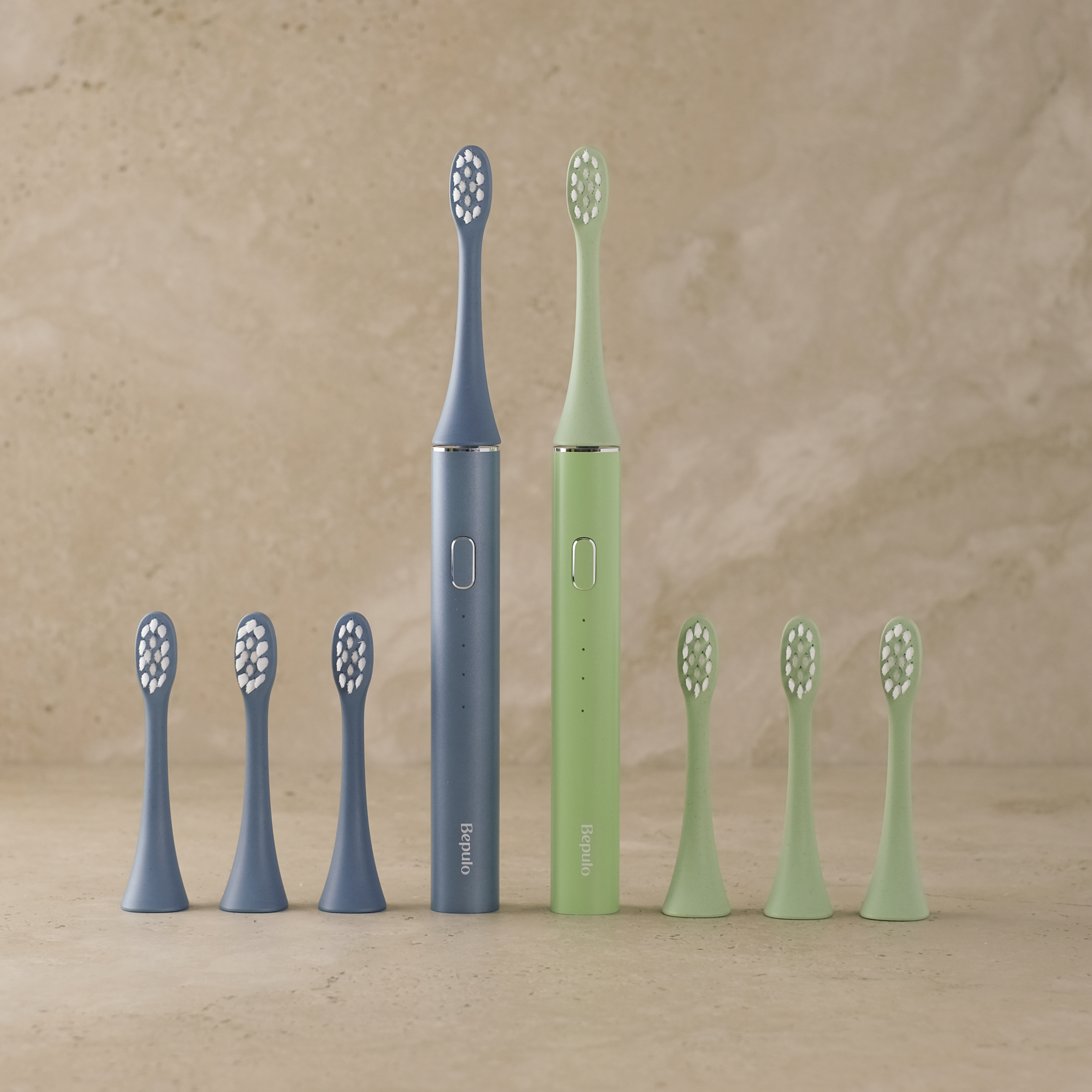 Blue and Green Bepulo Next standing on a travertine stone bench with spare brush heads either side. 