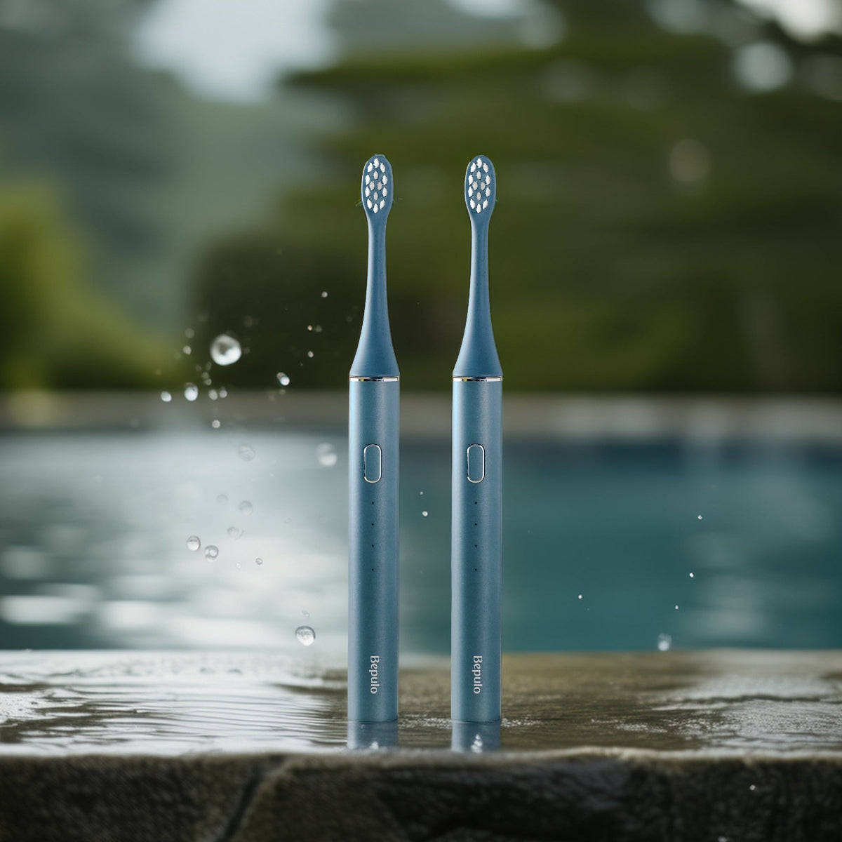 Two Bepulo Next sapphire blue sonic electric toothbrushes standing by an outdoor pool. #colour_sapphire blue