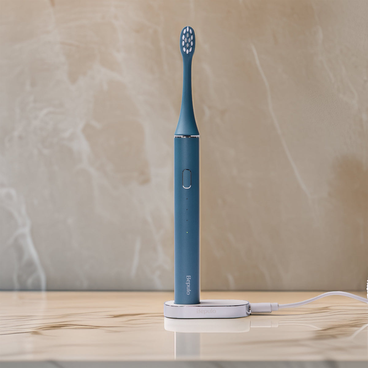 Bepulo Next sapphire blue sonic electric toothbrush standing on its magnetic charging base.