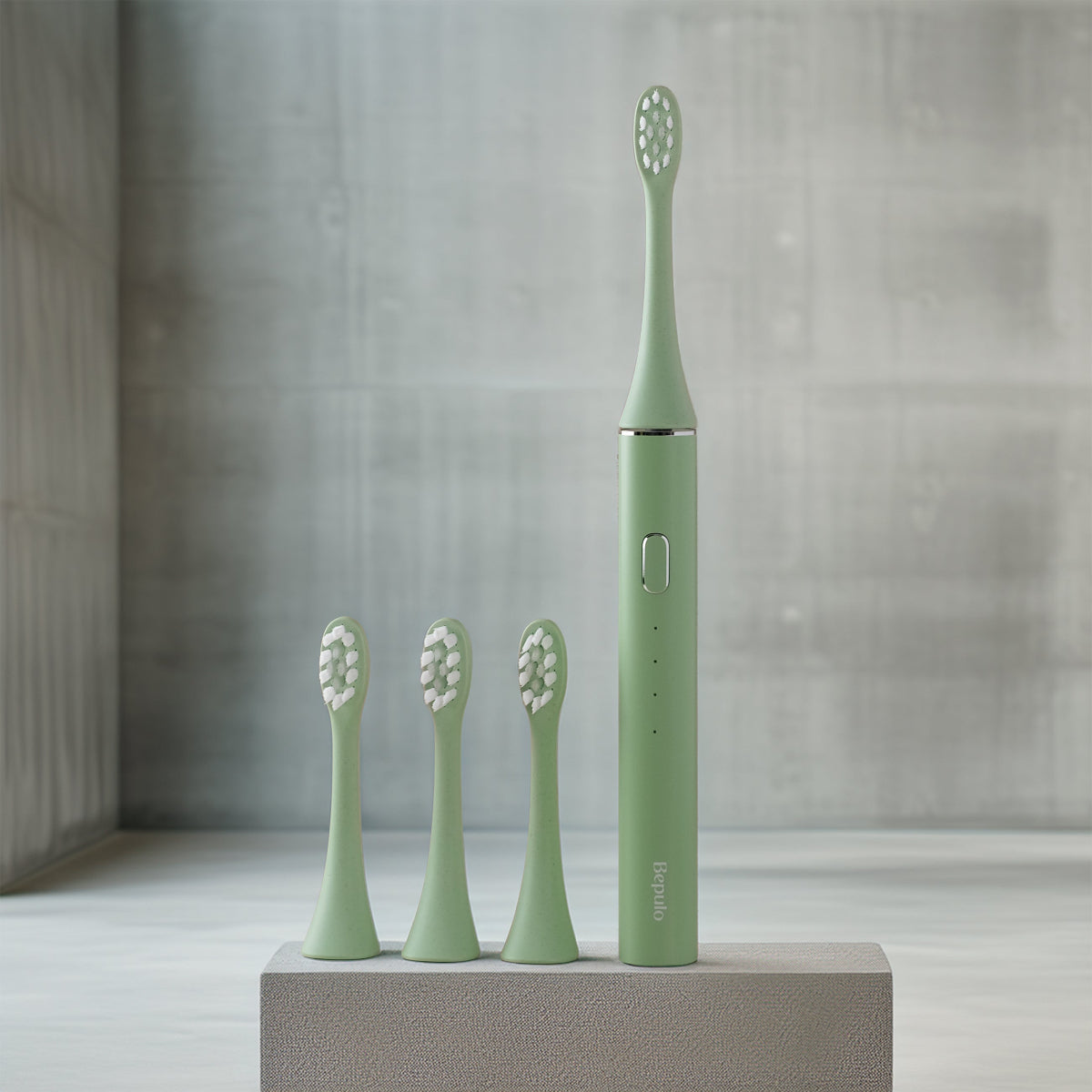 Bepulo Next pistachio green sonic electric toothbrush standing with three replacement brush heads. #colour_pistachio green